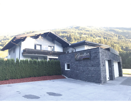 Exteriér obytného domu s garáží a příjezdovou cestou