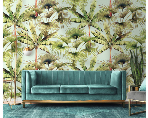 Ukázka interiéru s pohovkou, stojací lampou a dekorací před stěnou s tapetou s listovým vzorem