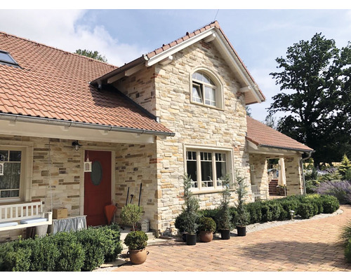 Fasáda domu s obkladovými cihlami a taškovou střechou