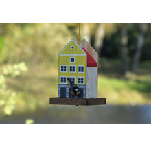 Krmítko pro ptáky v designu domu s ptákem
