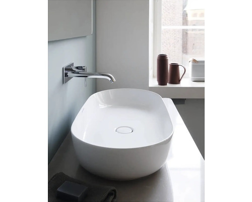 Keramické umyvadlo na desku v koupelně s vodovodní baterií