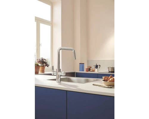 Kuchyňská scéna s dřezovou baterií, dřezem a kuchyňským náčiním na kuchyňské lince