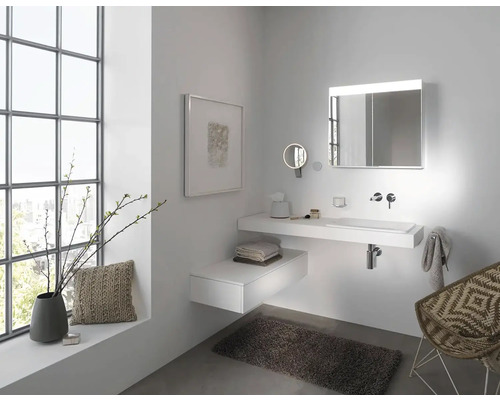 Světlá koupelna s umyvadlem, zrcadlem s osvětlením a dekorativními prvky