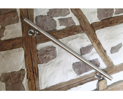 Nerezové madlo na stěně s kamennými a dřevěnými prvky