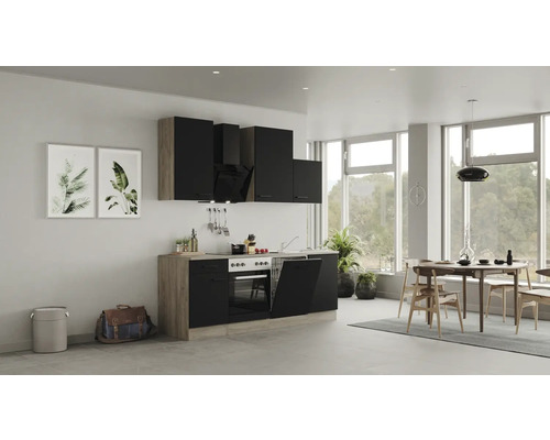 Moderní kuchyně s černými skříňkami, jídelním stolem a židlemi ve světlé místnosti.