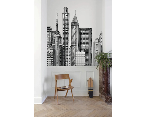 Pokoj s nástěnnou tapetou s motivem panoramatu města, dřevěnou židlí a skateboardem