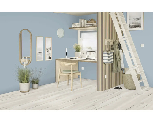 Světlá místnost s vyvýšenou postelí, psacím stolem, žebříkem a dekorativními prvky