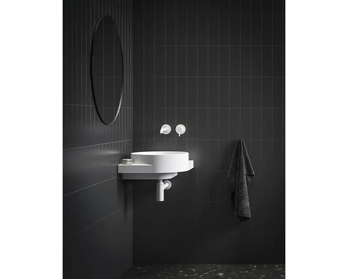 Moderní koupelna s kulatým zrcadlem, umyvadlem a armaturami