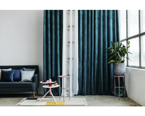 Obývací pokoj s pohovkou, odkládacími stolky, pokojovou rostlinou a závěsy