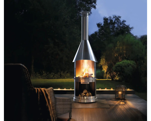 Nerezový venkovní krb s dřevem a ohněm na zahradě