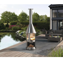 Venkovní nerezový krb s dřevem a grilem na terase se zahradním jezírkem