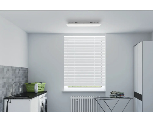 Světlá prádelna s pračkou, umyvadlem, košem na prádlo, sušákem na prádlo a žaluziemi