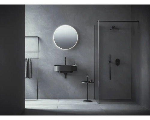 Moderní koupelna s umyvadlem, zrcadlem, držákem na ručníky a sprchou.