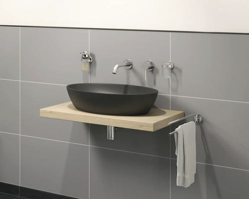 Moderní koupelna s černým umyvadlem na světlé dřevěné skříňce, baterií a držákem na ručníky