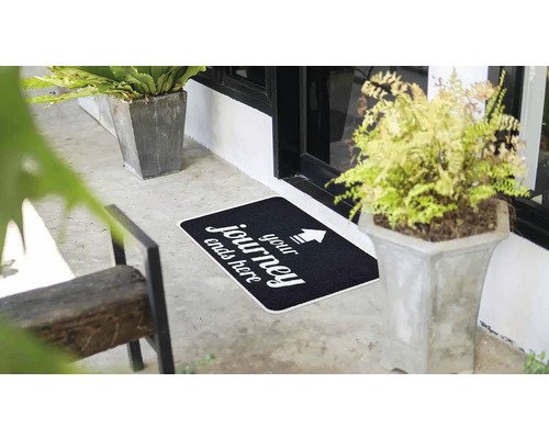 Rohožka s nápisem ''Your journey ends here'' před vchodovými dveřmi.