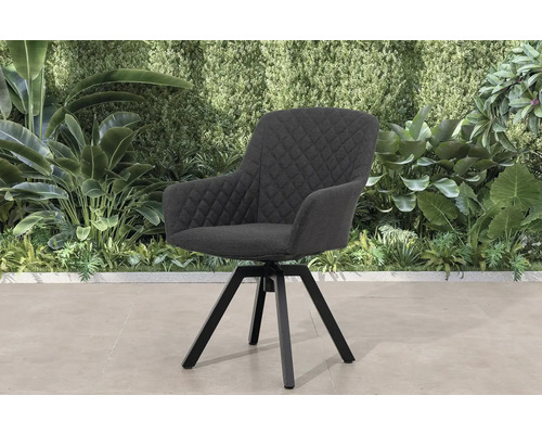 Otočná židle s područkami a prošívaným potahem před stěnou rostlin