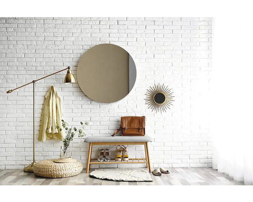 Vstupní prostor s lavicí, botami, zrcadlem a nástěnnou dekorací před bílou cihlovou zdí