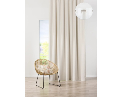 Dekorativní závěs s očky vedle ratanového křesla