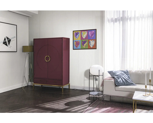 Obývací pokoj s červenou skříní, pohovkou a uměleckými díly na zdi