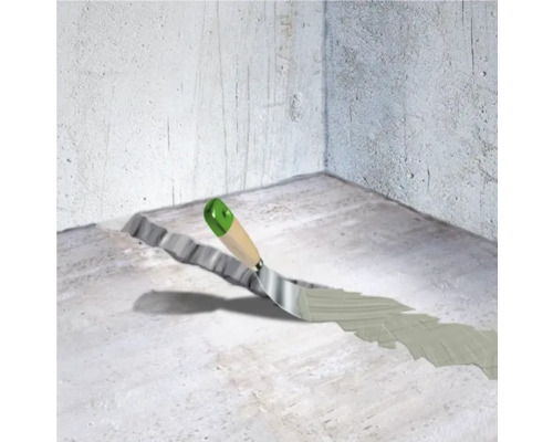 Zednická lžíce na betonové podlaze