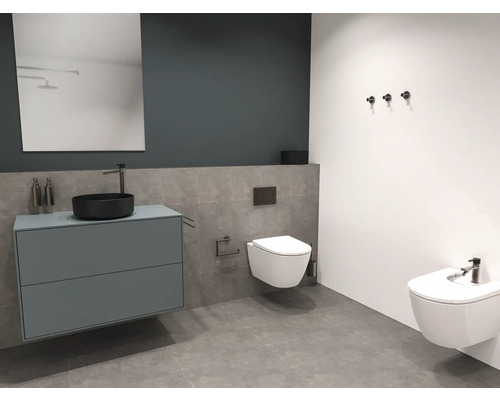 Moderní koupelna s umyvadlem, zrcadlem, toaletou a bidetem.