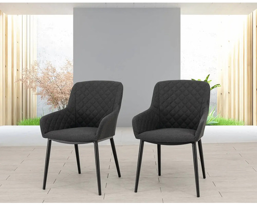 Dvě křesla s prošívaným povrchem a kovovýma nohama.