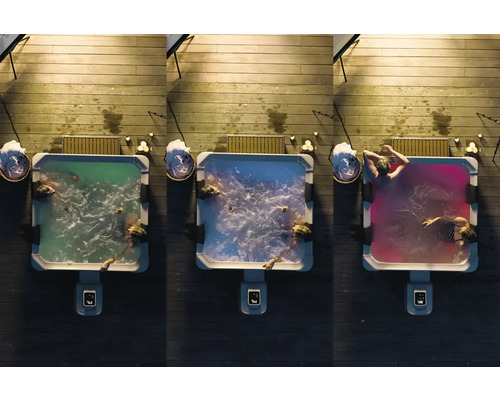 Pohled shora na tři vířivky s barevným osvětlením na dřevěné terase