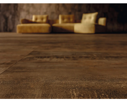 Detail tmavě hnědé podlahové krytiny s pohovkou v pozadí