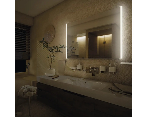 Moderní koupelna s osvětleným zrcadlem, umyvadlem a doplňky.