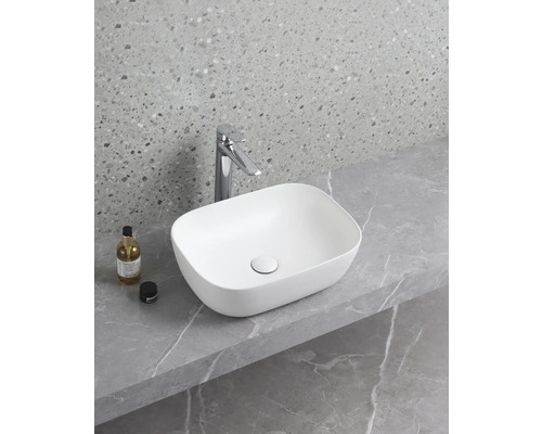 Keramické umyvadlo na desce s vodovodní baterií