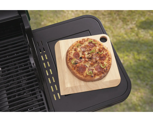 Pizza na dřevěném prkénku na grilovacím stole