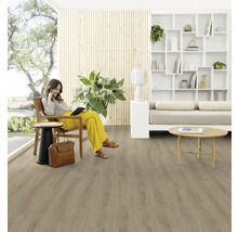 Obývací pokoj s dřevěnou podlahou a ženou sedící na židli