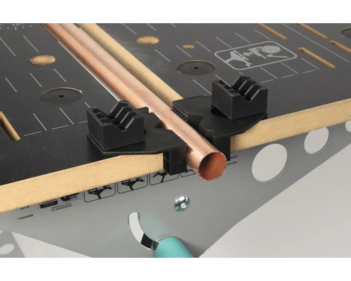 Měděná trubka na pracovní lavici s upínacím zařízením pro trubky