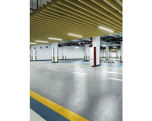 Interiérová fotografie podzemní garáže s betonovou podlahou, sloupy a stropním obkladem.