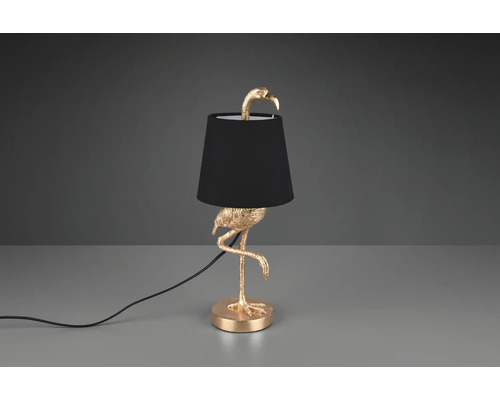 Dekorativní stolní lampa ve tvaru zlatého plameňáka s černým stínidlem.