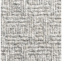 Detail světlého koberce s tkanou strukturou