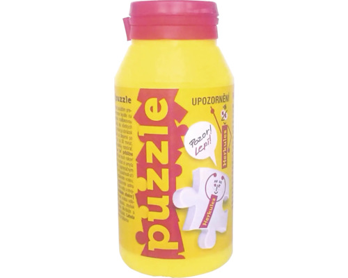 Lepidlo na puzzle v žluté lahvi s červeným víčkem