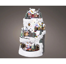 Vánoční miniaturní vesnice s domy, stromy, vlakem a lyžařským vlekem na zasněžené hoře