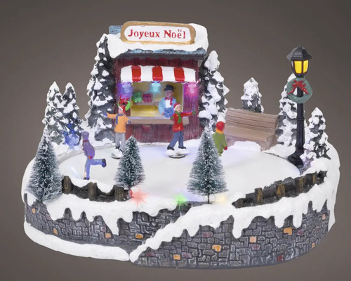 Dekorativní vánoční scéna s bruslaři, prodejním stánkem a osvětlením