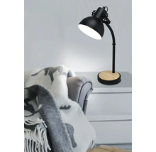 Stolní lampa s dřevěnou základnou na stole vedle křesla