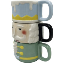 Tři naskládané hrnky s designem louskáčka