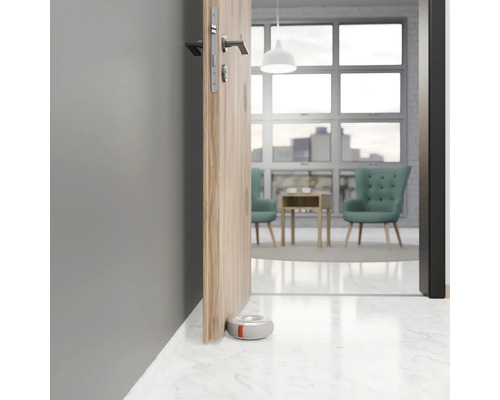 Interiér s částečně otevřenými dveřmi a kulatým dveřním dorazem