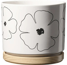 Květináč s květinovým vzorem a dřevěnou podložkou