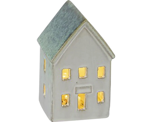 Dekorativní keramický dům s okny, které jsou osvětlené zevnitř