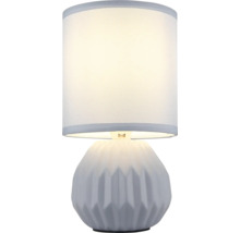 Stolní lampa s válcovým stínidlem a geometricky vzorovanou základnou