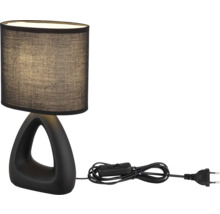 Stolní lampa s tmavým stínidlem a trojúhelníkovou základnou