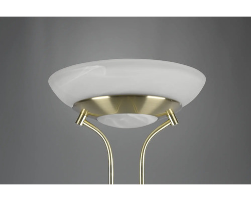 Detailní záběr stojací lampy se skleněným stínidlem a kovovým rámem