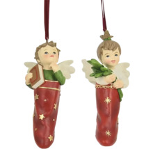 Dvě figurky andělů jako ozdoby na vánoční stromeček s knihou a větvemi