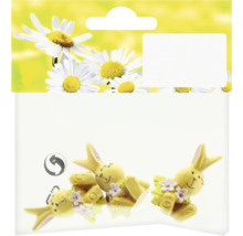 Balení se třemi žlutými figurkami zajíčků s květinovou výzdobou