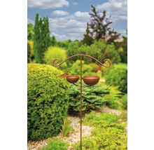 Pítko pro ptáky se dvěma miskami a figurkou ptáka na zahradě